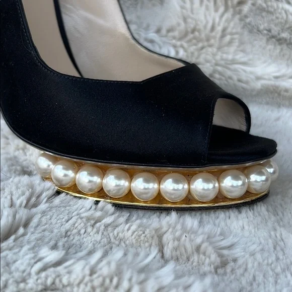 Nicholas Kirkwood black sling-back heals with signature pearl platform.